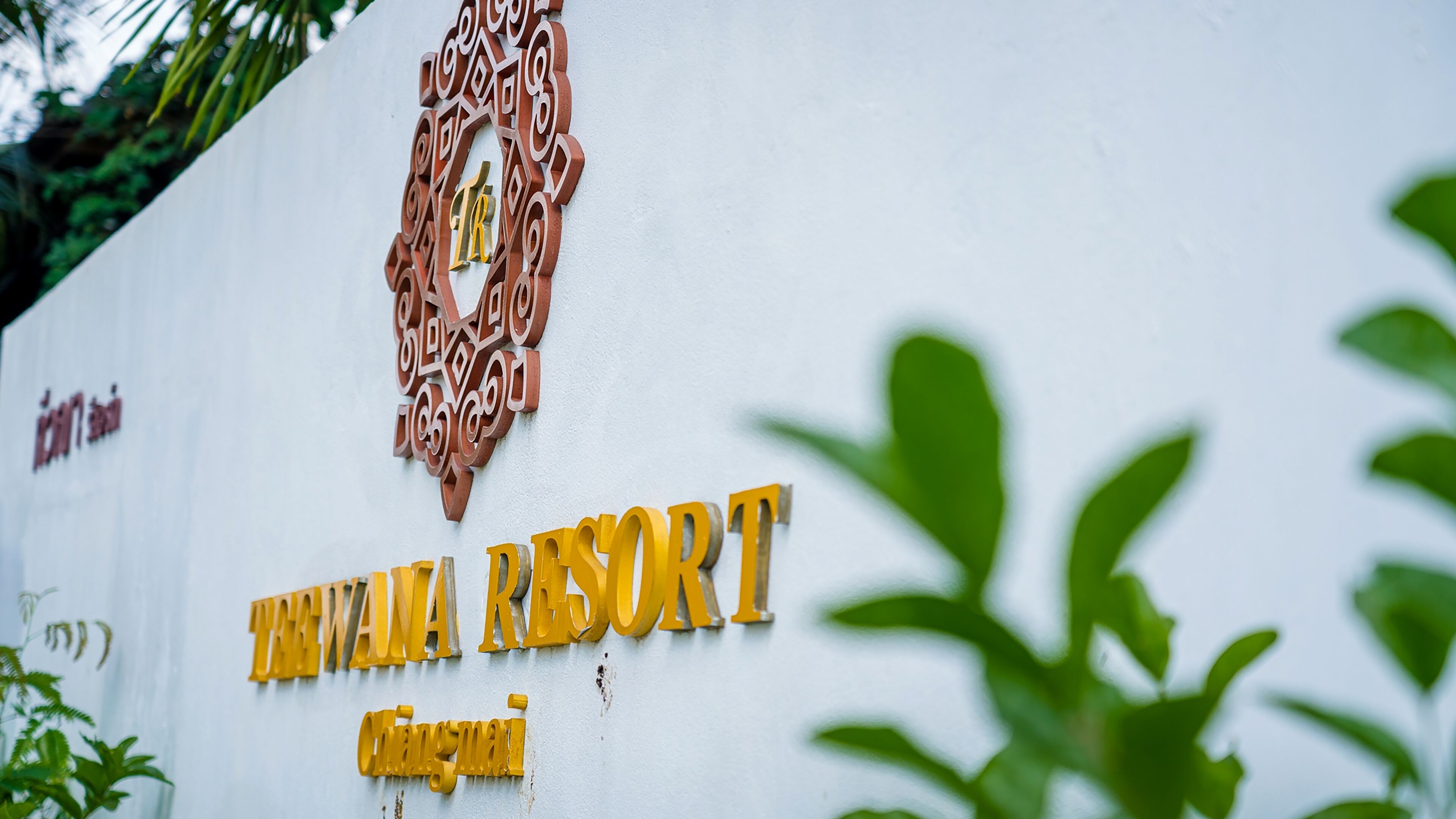 A sign for 'Tiwara Resort' with a decorative emblem above the name.
