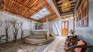 A courtyard with a concrete staircase, wooden chairs, and a wooden door. - Teewana Resort Chiang Mai (Hang Dong)