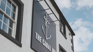 A building with a sign reading "The Camel Inn" featuring a white anchor logo. - The Canal Inn (Belper)