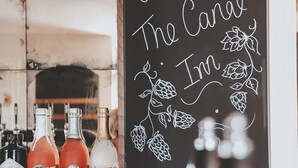A bar area with a chalkboard sign reading "Welcome to The Canal Inn." - The Canal Inn (Belper)
