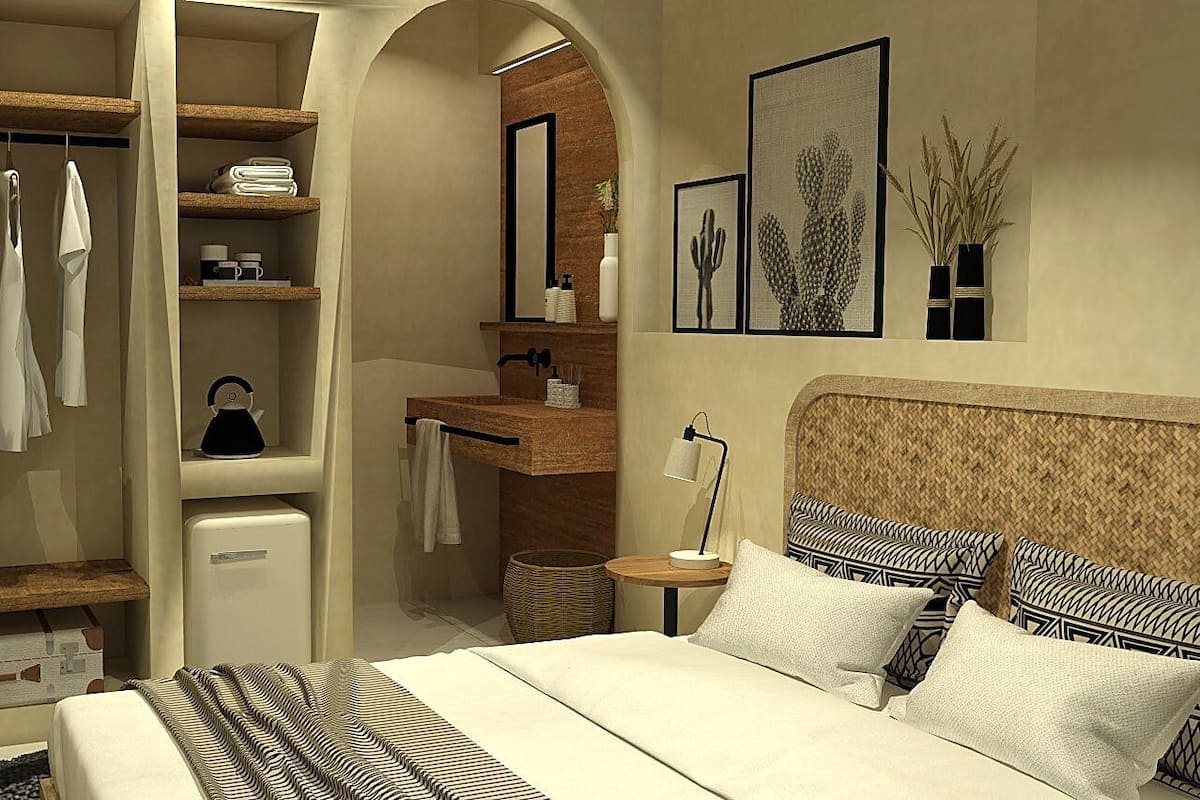 Un dormitorio con cama, mesita de noche, armario y tocador en el baño.