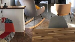 A living room with a large world map, a television, and modern furniture. - Maison en Pierres Avec vue sur mer et les Îles (Bormes-les-Mimosas)