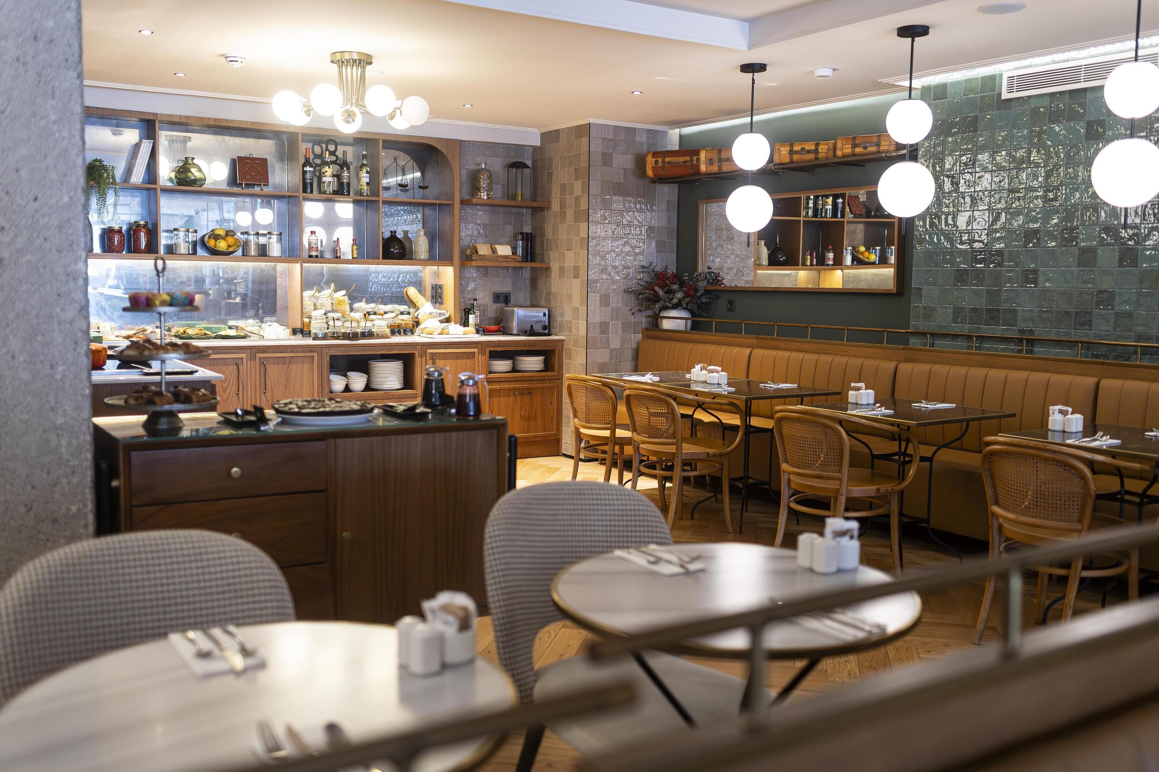 A restaurant with a bar area, wooden furniture, and a variety of food and drink items displayed on shelves.