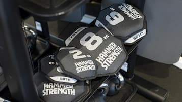 A set of dumbbells labeled with weights and the brand "Hammer Strength."