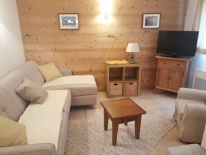 Relax in this inviting living room with a sofa, armchair, and coffee table.