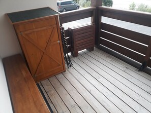Enjoy an outdoor space with a cabinet and bench.