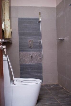 Shower, slippers, towels - Century Lake View Apartments (Jinja)