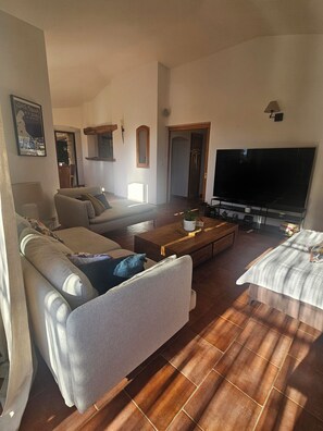 Smart-tv, eldstad, dvd-spelare och ett bordtennisbord