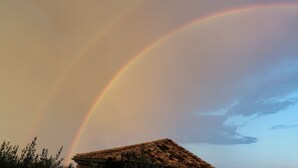 A house with a tiled roof and a visible rainbow in the sky. - Chambre Dans Maison de Caractère Proche du Mt Ventoux (Crillon-le-Brave)