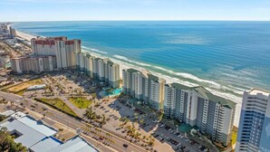 A coastal hotel with multiple high-rise buildings, a parking lot, and a beach view. - Stunning oceanfront condo in Panama City Beach, perfect for up to 8 guests! (Panama City Beach)