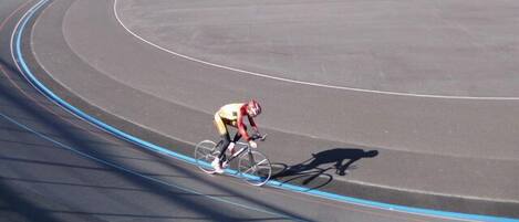 A velodrome with a cyclist in motion.