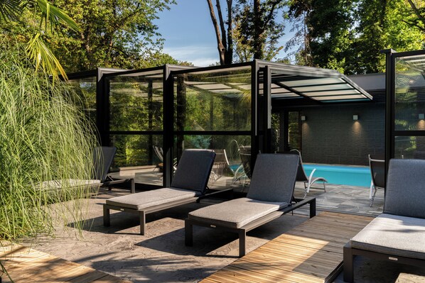 Indoor pool, open 9:30 AM to 8:30 PM, pool umbrellas, pool loungers