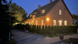 Ett hus byggt av tegel med en uppfart och en välskött gräsmatta.