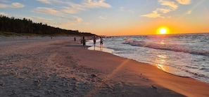 A beach with people walking along the shore during sunset. - Beautiful old house by the Baltic Sea  (Mielenko)