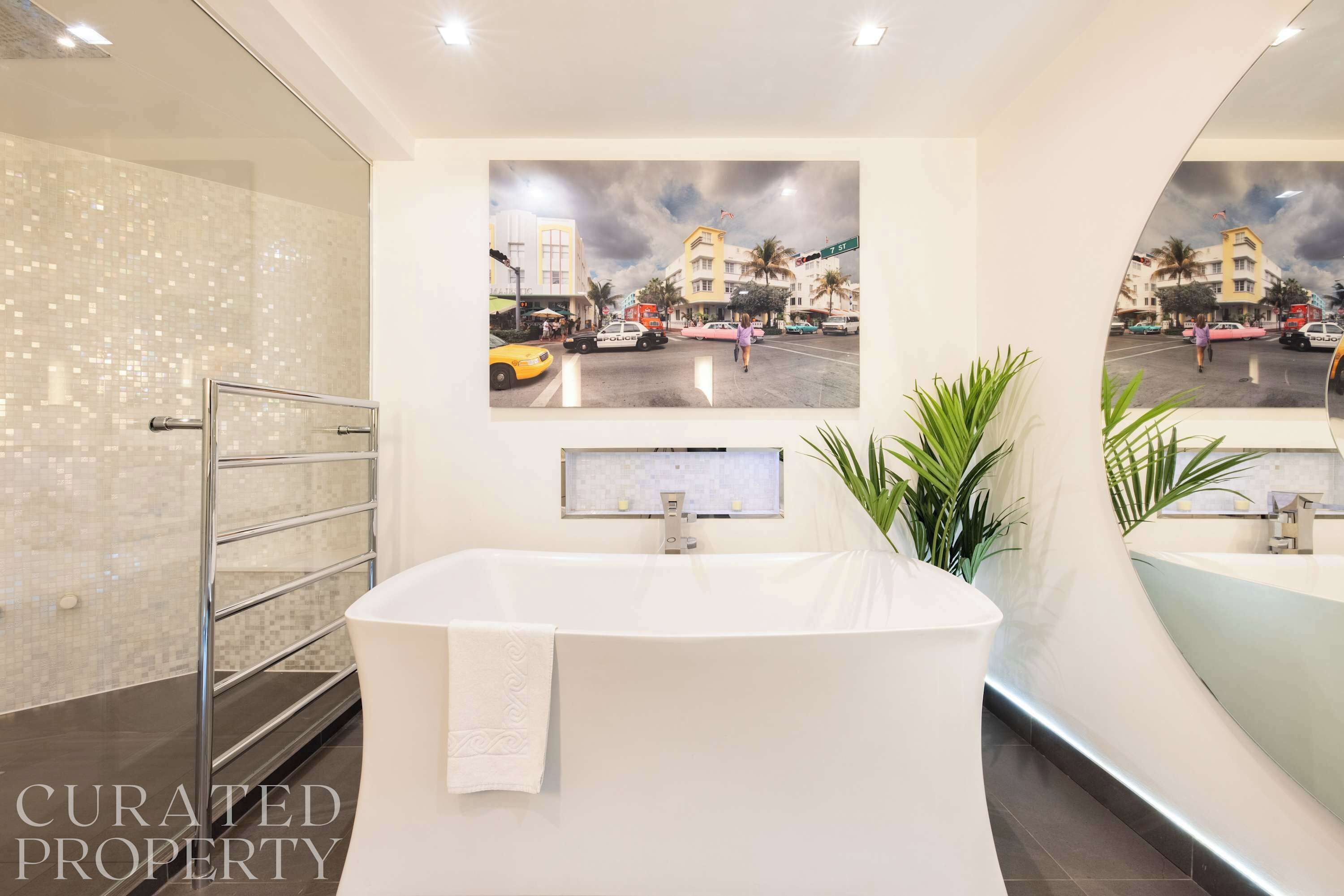 A modern bathroom with a large bathtub, a glass shower enclosure, and a wall-mounted mirror.