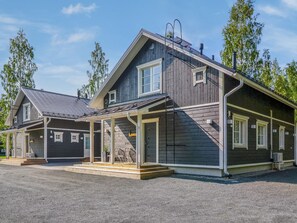 A two-story building with a covered porch and a garage.