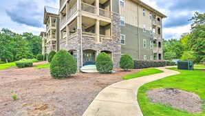 A multi-story building with a stone facade, balconies, and a well-maintained lawn. - Pool & Boat Dock! Logan Martin Lake Extended Stay (Talladega)