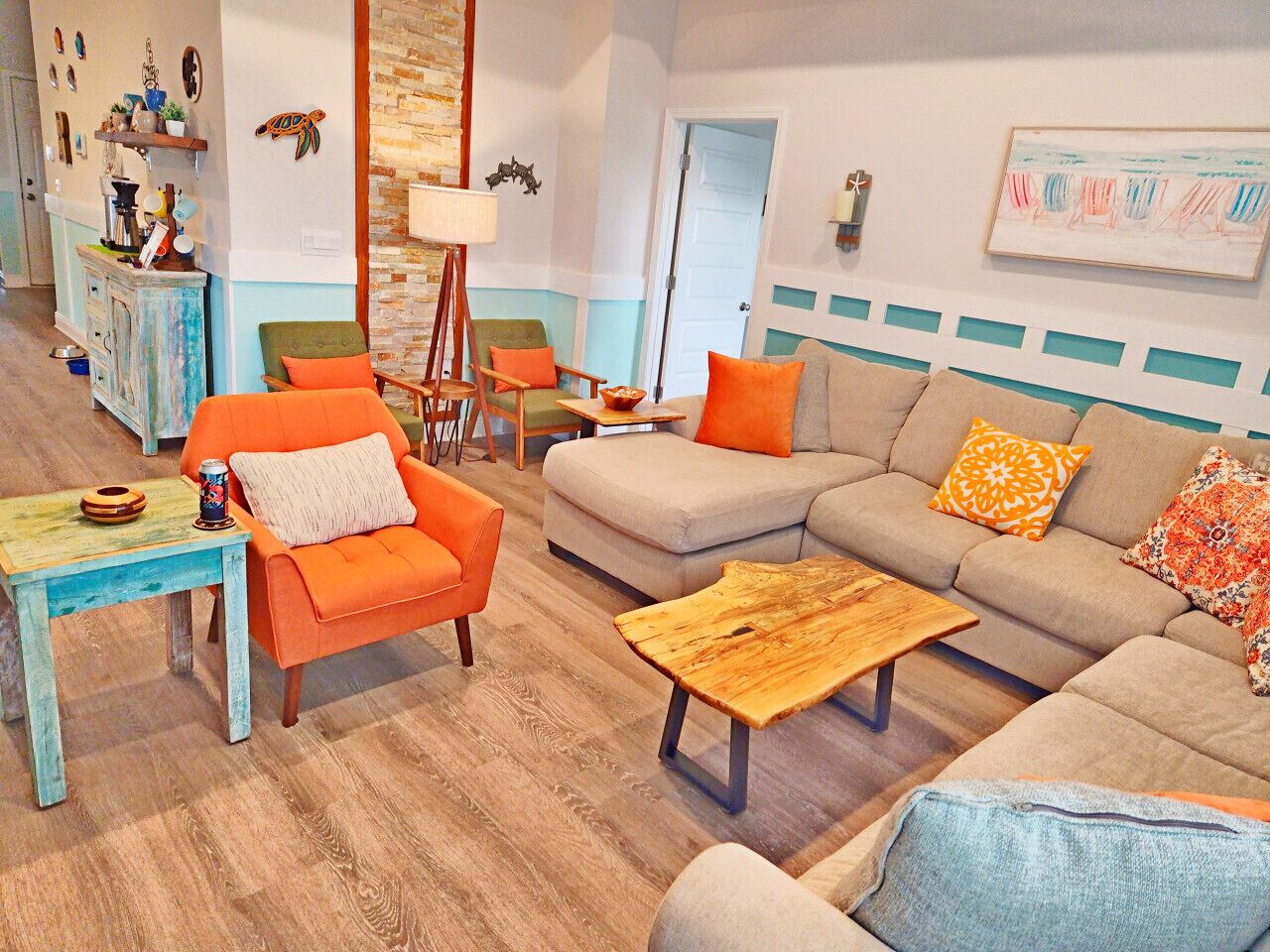 A living room with a sofa, armchairs, a coffee table, and a side table.
