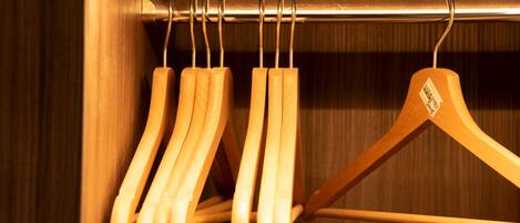A wooden hanger rack with multiple hangers.