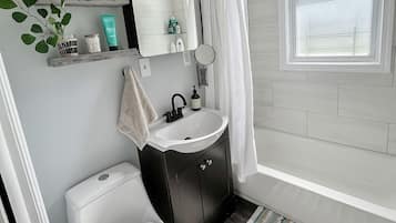 Bathtub, hair dryer, towels, soap
