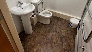 A small bathroom with a sink, toilet, and mirror. - 1 Bedroom Flat - Lace Market Nottingham (Nottingham)