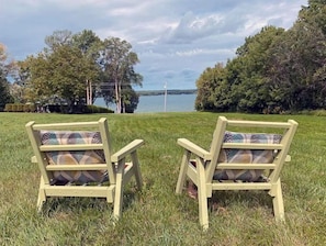 Guests can sit and enjoy the serene views of the water from the Adirondack chairs on the lawn.