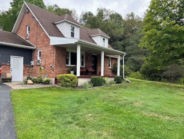 Stroll up to this charming two-story home with a welcoming front porch and beautifully manicured lawn.