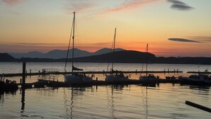 Un puerto deportivo con barcos amarrados al muelle durante el atardecer.