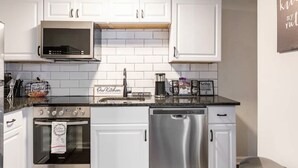 A modern kitchen with white cabinets, a microwave, an oven, and a dishwasher. - 🔥 Spacious 3BR Basement APT near ATL Airport/ 10 Mins Downtown! Sleeps 8🔥 (East Point)