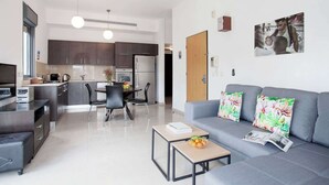 A modern apartment with a kitchen, dining area, and living room. - Cute Shenkin area 1BR By Holiday-rentals SAFE ROOM ({{addressCityy}})