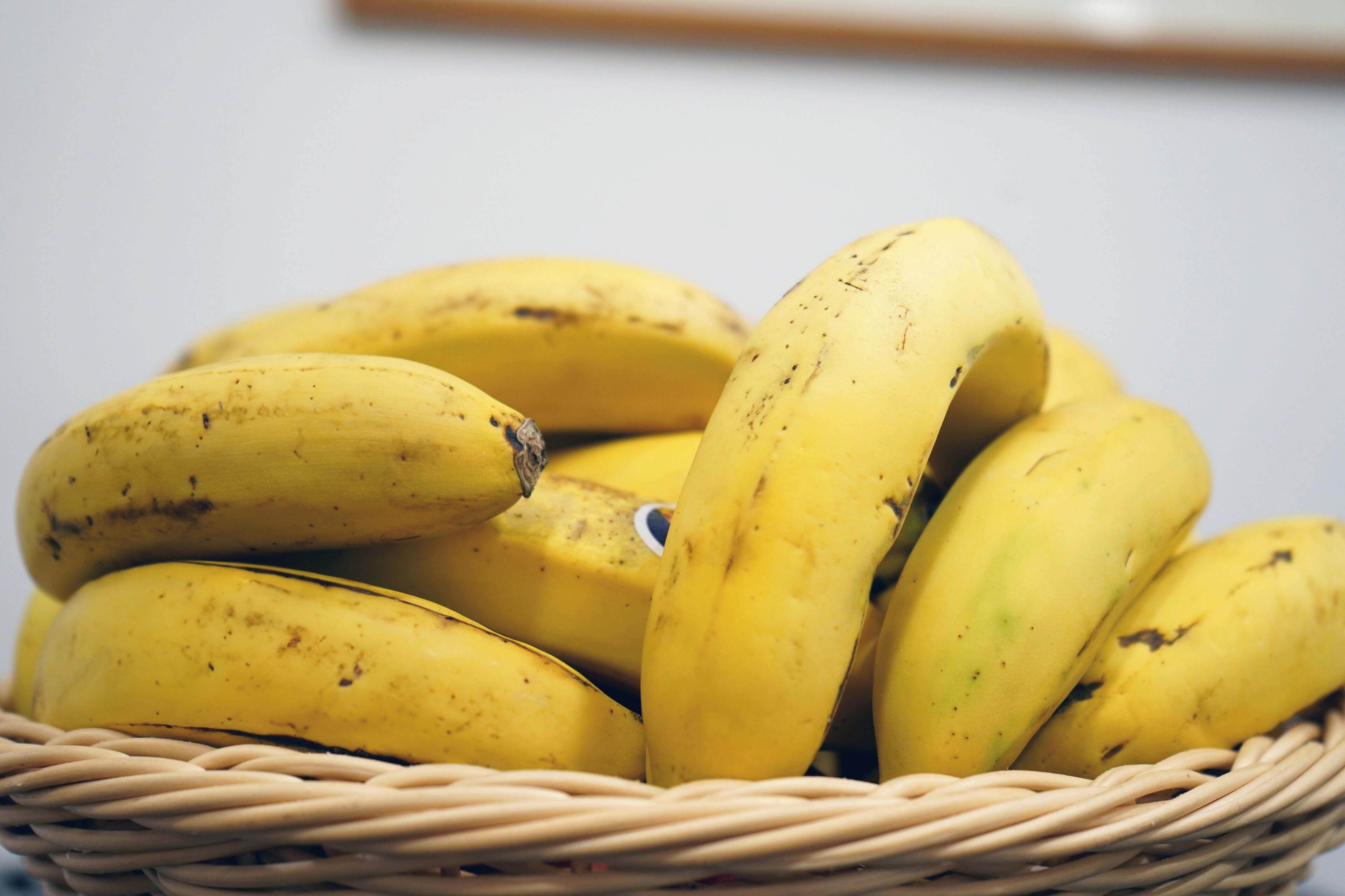 A wicker basket filled with bananas.