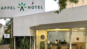 The exterior of the Appel Hotel with a reception area visible through the glass doors. - HOTEL APPEL (Santa Maria)