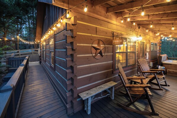A wooden cabin with a deck, rocking chairs, and string lights. - ⭐️ Mountain view • hot tub • game table • dogs welcome ⭐️ (Blue Ridge)