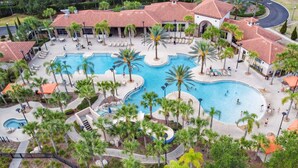 A resort with multiple swimming pools, palm trees, and lounge areas. - All the best family comforts at this very popular 5 bedroom home (Davenport)