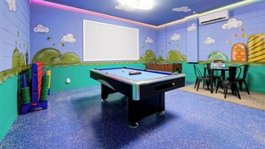 A room with a pool table, a foosball table, and a table with chairs. - All the best family comforts at this very popular 5 bedroom home (Davenport)