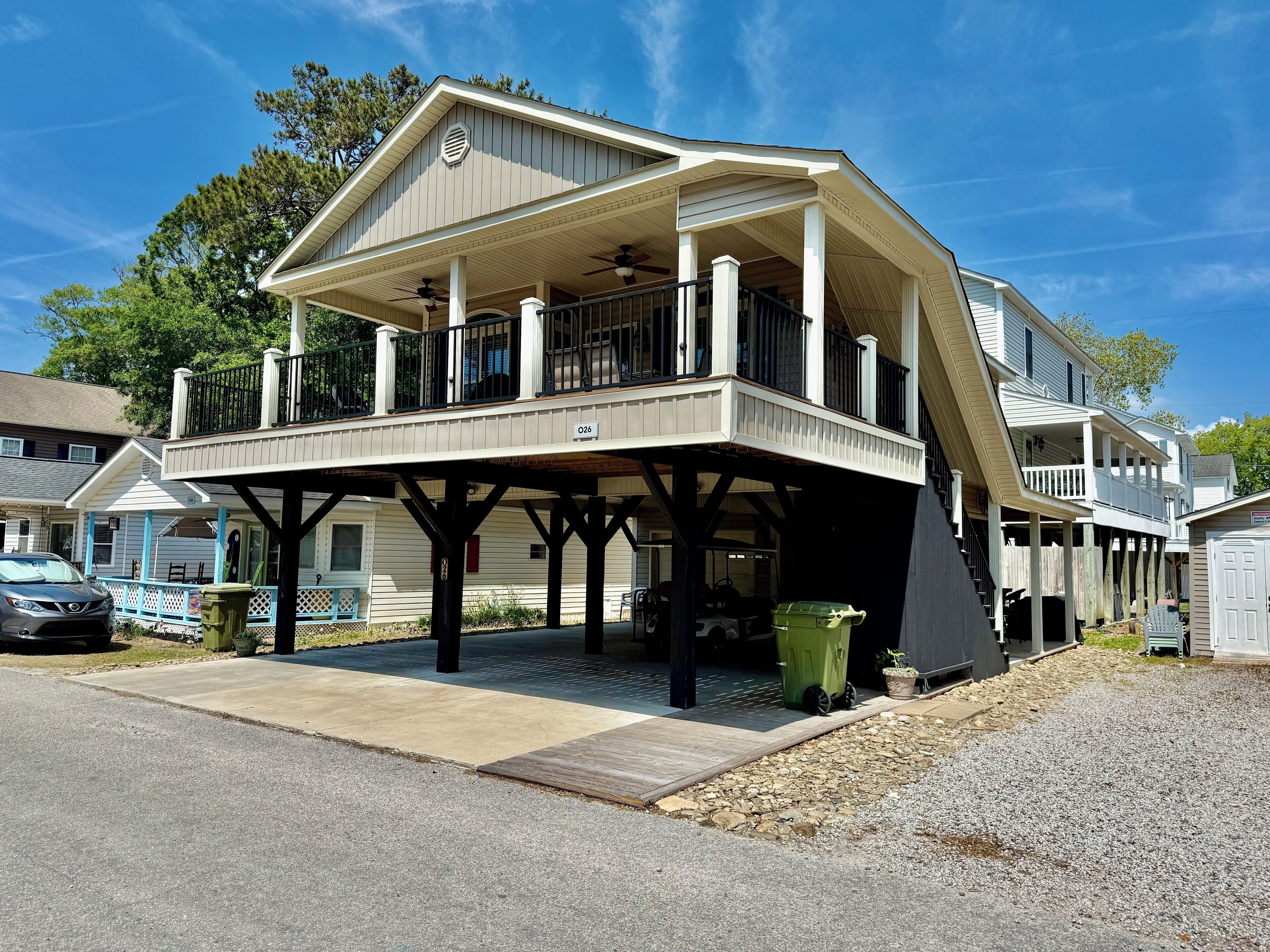 A two-story house with a covered porch and a garage.