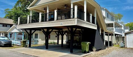 A two-story house with a covered porch and a garage.