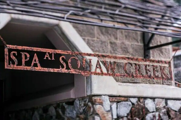 A sign for "Spa at Sonoma Creek" with a rustic, weathered appearance.