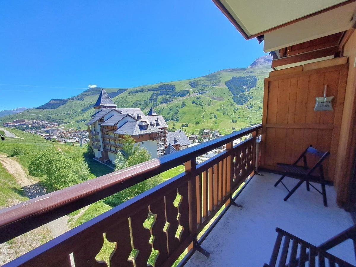 A balcony with a view of a village and mountains.