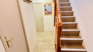 A staircase with wooden handrails leading to an upper floor.