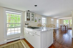 Enjoy cooking in this well-equipped kitchen with a central island and stove.