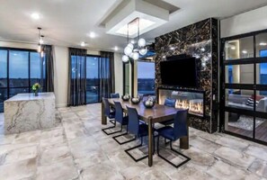 Enjoy meals in the dining area with a flat-screen TV and fireplace.
