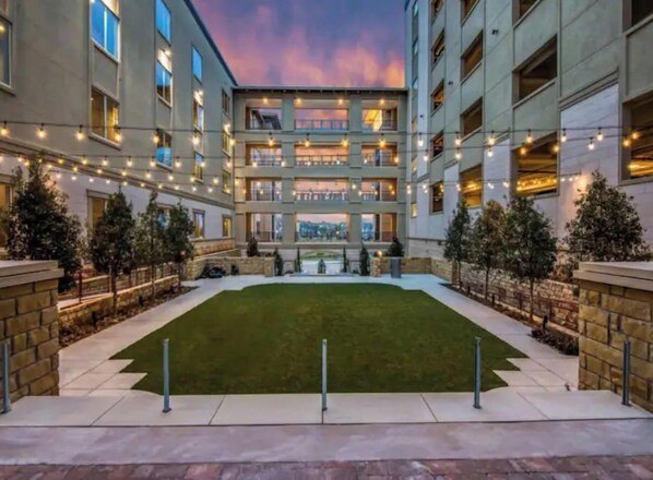 Stunning building with a symmetrical facade and beautifully maintained courtyard.