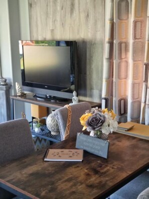 Relax in this inviting living area with a TV, sofa, and coffee table.