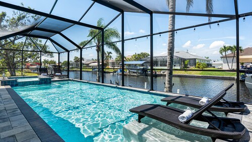 Gulf access pet friendly waterfront oasis with NEW heated salt water pool & spa 