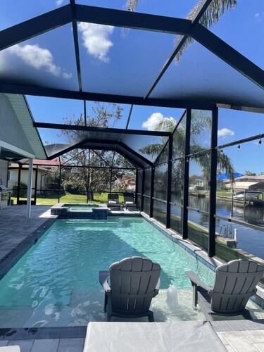 Gulf access pet friendly waterfront oasis with NEW heated salt water pool & spa 