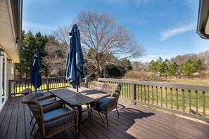A wooden deck with wicker furniture and a table, overlooking a grassy area with trees. - "Murray Mill Ranch" — Classy ranch retreat next to Murray Mill; quiet & private (Catawba)