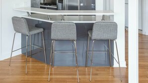 A modern kitchen with a central island, stainless steel appliances, and bar stools. - Luxury Fulton Market Penthouse Amazing City Views (Chicago)