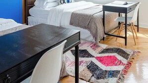 A modern bedroom with a bed, a desk, and a large window offering a city view. - Luxury Fulton Market Penthouse Amazing City Views (Chicago)