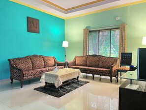 Relax in this stylish living room with two sofas, a small table, and a television.